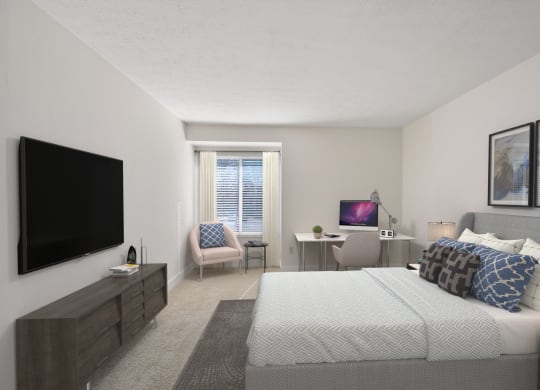 a bedroom with a large bed and a flat screen tv at Harpers Point Apartments, Cincinnati, Ohio