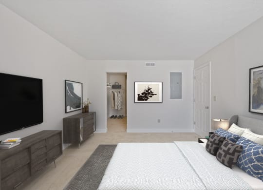 a bedroom with a large bed and a tv at Harpers Point Apartments, Cincinnati, OH, 45249