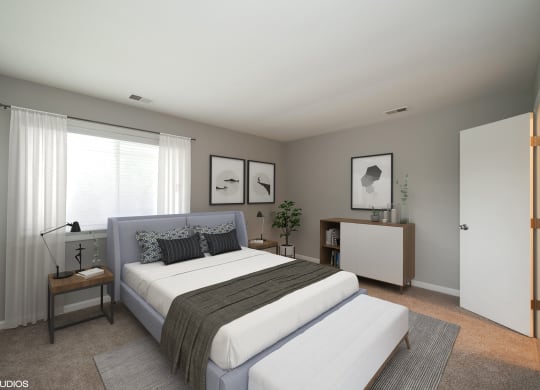 a bedroom with a bed and a dresser  at 7 Pointe Apartments, Indianapolis, IN, 46205