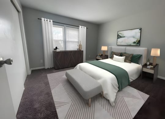 a bedroom with gray walls and a white bed with a green blanket