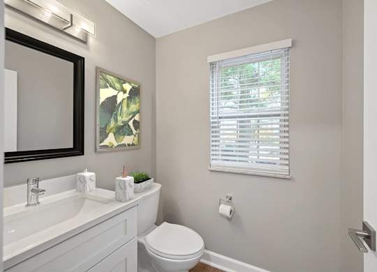a bathroom with a toilet and a sink and a window at Indian Creek Apartments*, Ohio, 45236