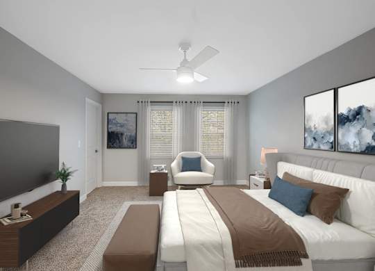 a master bedroom with a large bed and a ceiling fan at Indian Creek Apartments*, Cincinnati, OH