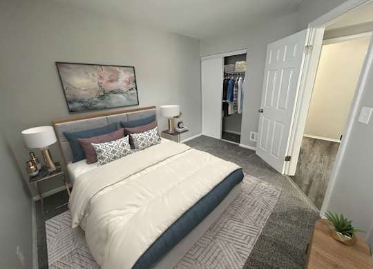 A bedroom with a large bed and a painting on the wall.