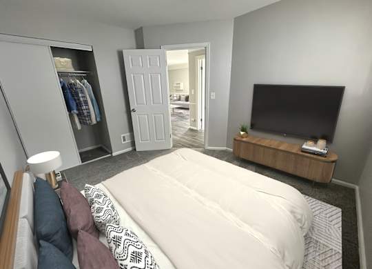 A bedroom with a large bed, a television, and a wardrobe.