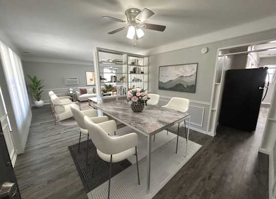 A dining room with a table and chairs.