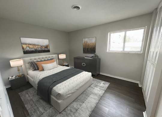 A bedroom with a large bed, a nightstand, and a painting on the wall.
