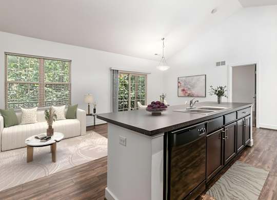 A modern kitchen with dark wood cabinets and a white island. at River View at Bexley Apartments, River View at Bexley 43209