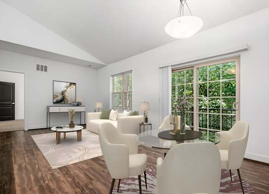 A modern dining room with a glass table and white chairs. at River View at Bexley Apartments, River View at Bexley, Ohio