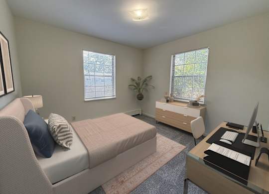 A bedroom with a bed, desk, and chair.