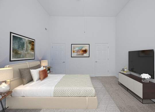 A bedroom with a bed, a nightstand with a lamp, a television, and two framed pictures on the wall.