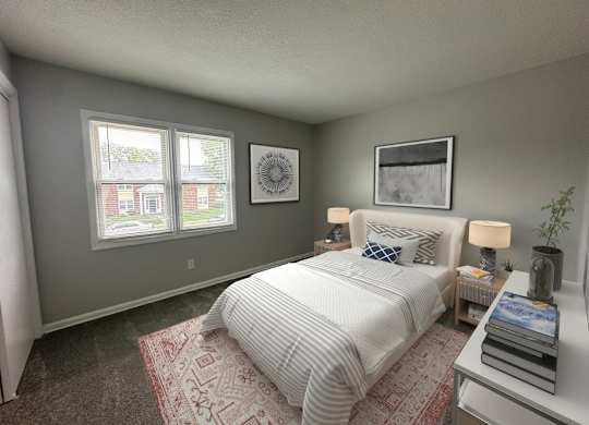 A bedroom with a bed, nightstand, and two framed pictures on the wall.