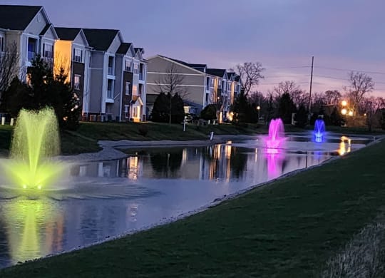 a pond with fountains in front of an apartment complex at Waterstone Landing, Ohio, 43551