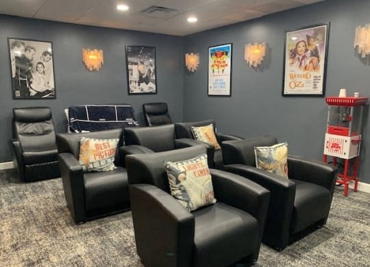 a room with a bunch of chairs and pictures on the wall