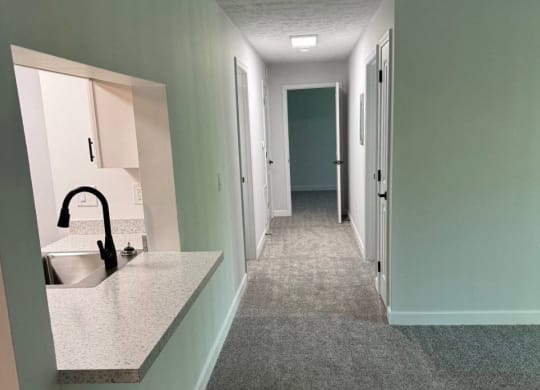 Hallway with a sink and a mirror in a house  at Hilltop Apartments, Cincinnati, OH