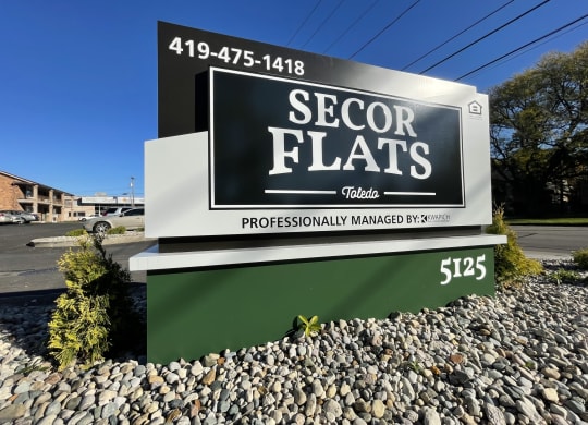 a sign in front of a building that says sector flats