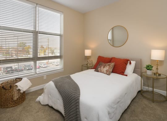 a bedroom with a white bed and two windows at Adelphi Quarter, Columbus, 43203