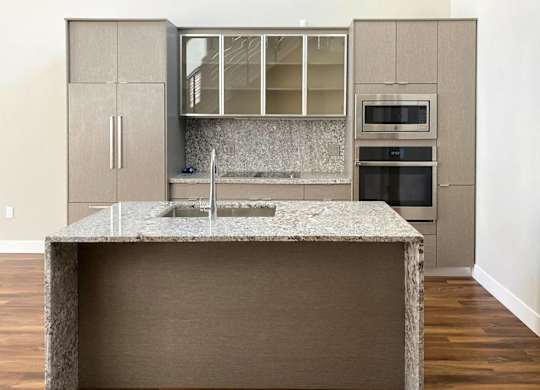 A kitchen with a granite countertop and a sink.at Sky Central, Cincinnati, 45202