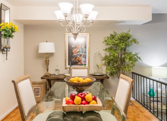 a dining room with a glass table with fruit on it