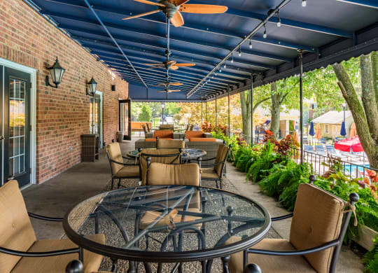 a patio with tables and chairs and a blue ceiling