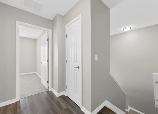 a renovated living room and hallway with a door to a closet at Traditions at Slate Ridge, Ohio