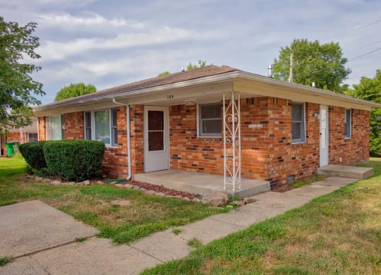 a small brick house with a porch at Stonebrook of Franklin, Franklin
