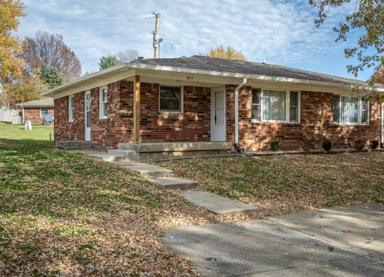 a small brick house with a sidewalk in front of it  at Stonebrook of Franklin, Franklin