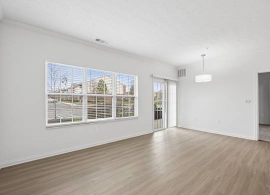 A room with a large window and a sliding glass door.