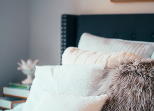 a bed with pillows and a blanket on it