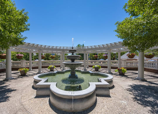 a fountain in the center of a park with a pergola at Bishops Gate, Cincinnati