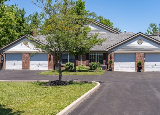 a house with two garage doors and a tree in front of it at Bishops Gate, Cincinnati, OH, 45249