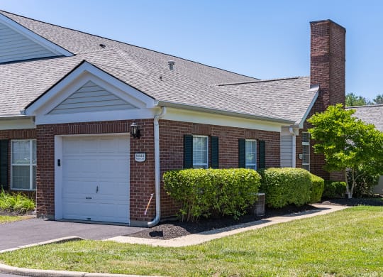 a brick house with a white garage door at Bishops Gate, Ohio, 45249