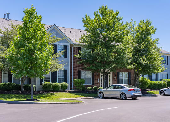 an apartment building with two cars parked in front of it at Bishops Gate, Ohio