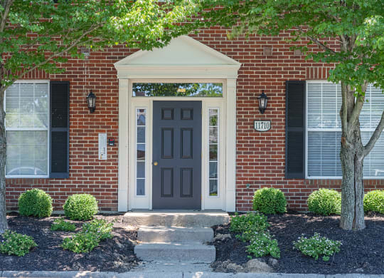 a red brick house with a black door at Bishops Gate, Cincinnati, 45249