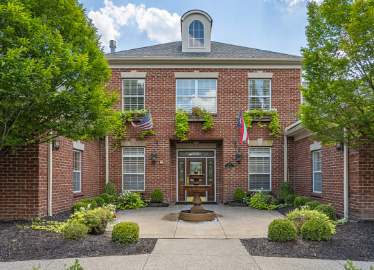 a front view of a brick building with a fountain at Bishops Gate, Cincinnati, OH, 45249