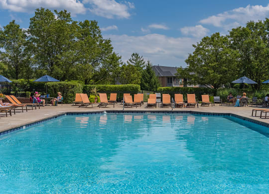 a swimming pool with chairs and umbrellas at the resort on a sunny day at Bishops Gate, Ohio
