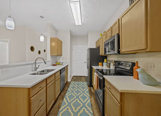 Kitchen with wooden cabinets and sink at Bishops Gate, Cincinnati, 45249