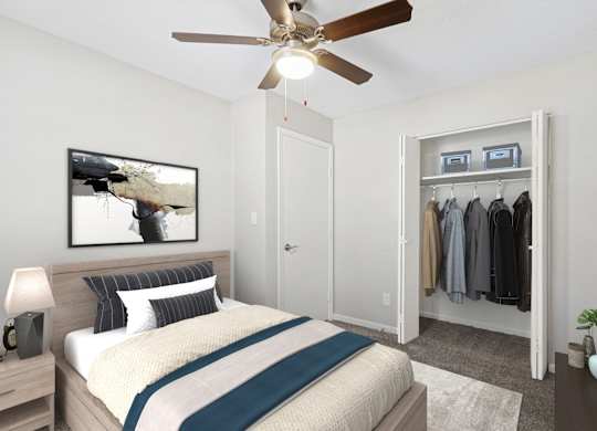 A bedroom with a bed, a ceiling fan, and a closet.