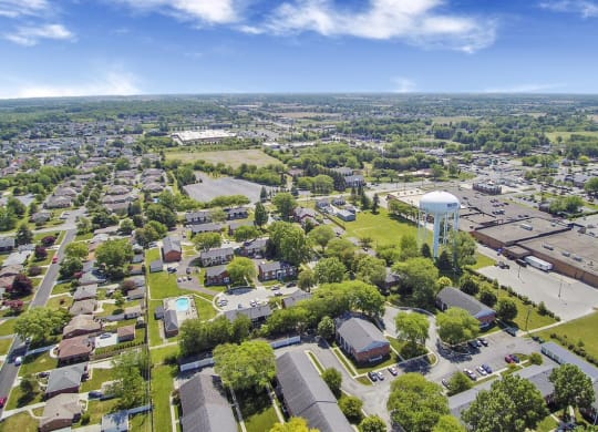 an aerial view of a city with a water tower in the middle of it