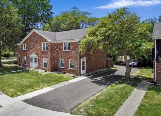 a red brick house with a gray roof
