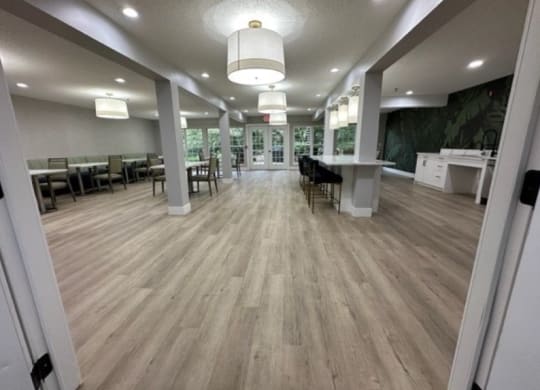 a large room with hardwood floors and white pillars