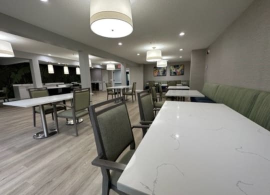 a large dining room with tables and chairs