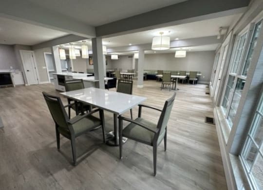 a dining area with a table and chairs