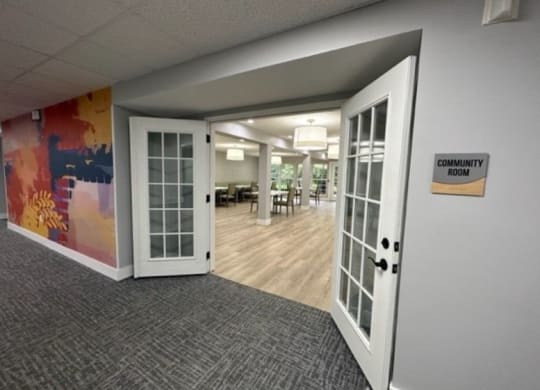an open door leading into a room with a colorful mural on the wall
