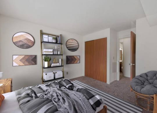 a bedroom with a bed and a chair in a 555 waverly unit at The Woodridge Collection, Ohio, 45014
