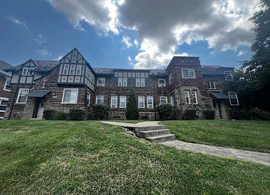a large brick building with a cloudy sky in the background at Cincinnati Premier Living*, Cincinnati, Ohio