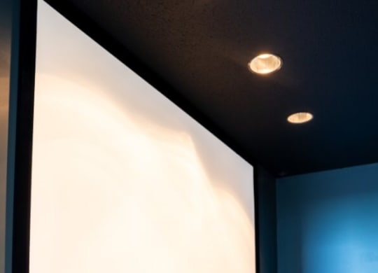 Projector screen in a blue room with a wooden table at Waterstone Landing, Perrysburg, OH, 43551
