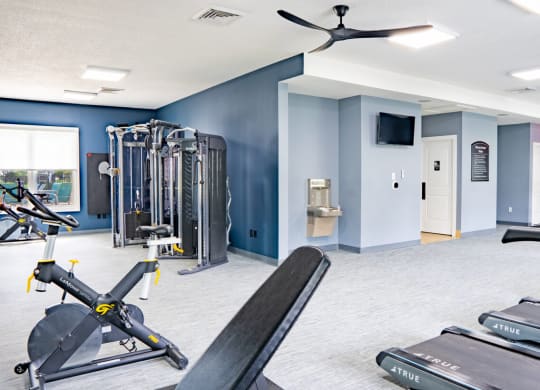 Gym with weights and cardio machines and a wall mounted tv at Waterstone Landing, Ohio, 43551