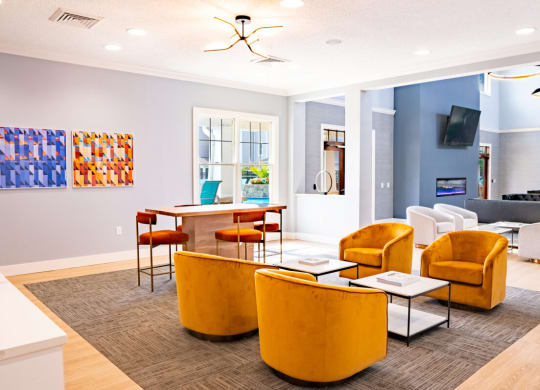 Living room with yellow chairs and a table with a laptop at Waterstone Landing, Perrysburg, OH, 43551