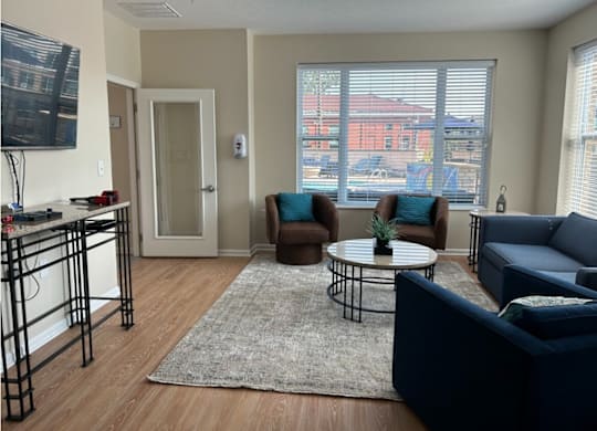 an apartment living room with couches and a table