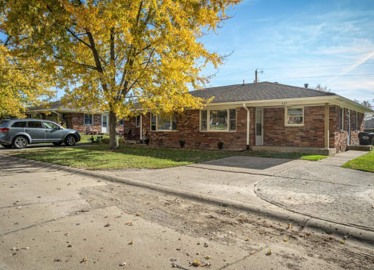 a small brick house with a car parked in the driveway at Stonebrook of Franklin, Franklin